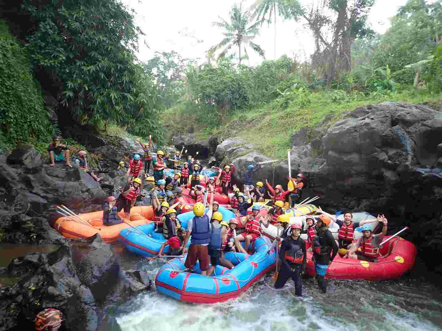 A group of people on a raft in a river

Description automatically generated