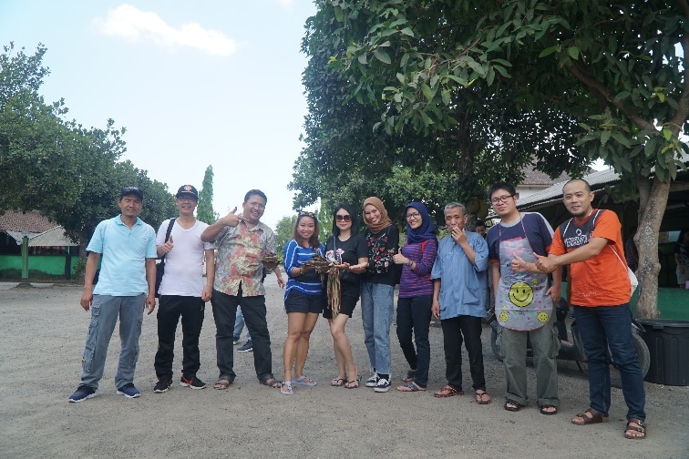 A group of people standing in front of a crowd posing for the camera

Description automatically generated